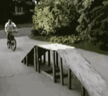 a pixelated image of a person riding a bike on a sidewalk