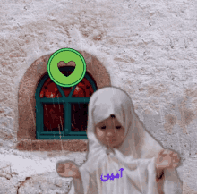 a little girl wearing a white shirt with the name amin written on it