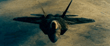 a fighter jet is flying over the desert and looking down at the camera