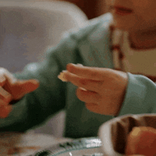 a close up of a person 's hands eating food