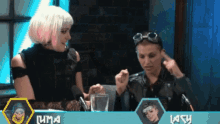 two women are sitting in front of microphones and a sign that says luma