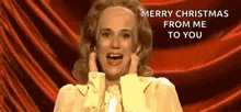 a woman is saying merry christmas from me to you