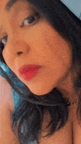 a close up of a woman 's face with red lipstick on her lips