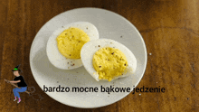 hard boiled eggs on a white plate with a witch on a broom