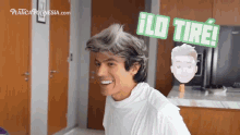 a man in a white shirt is smiling in front of a sign that says " ilo tire "