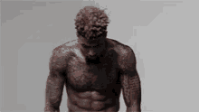 a shirtless man with a lot of tattoos on his chest and arms