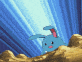a blue rabbit with a pink nose is standing on a rocky hillside