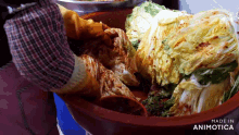 a person is putting food in a bowl that says made in animotica on the bottom
