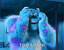 a monster from the movie monsters inc is covering his eyes with his hands .