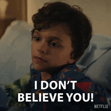 a young boy says i don 't believe you while laying in bed