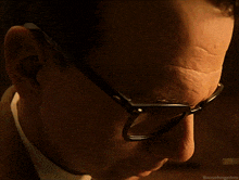 a close up of a man 's face wearing glasses with the hashtag @anunhinedme