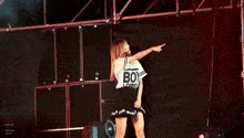 a woman is dancing on a stage with a shirt that says 101 on it
