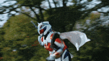 a person in a superhero costume with a white cape is flying through the air