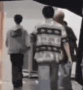 a blurry picture of a group of people standing next to each other .