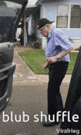 a man in a plaid shirt is standing in front of a house with the words blub shuffle written below him