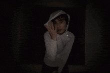 a blurry image of a person wearing a white hoodie