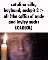 a man is holding a lit candle in front of a text that says catalina ville