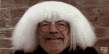 a man wearing glasses and a white wig with fx written on the bottom right