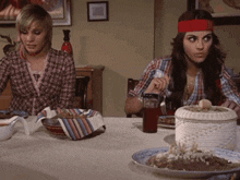 a woman with a red headband sits at a table with other women