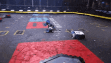 a couple of robots are playing a game on a dirty track .