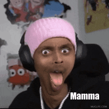 a man wearing headphones and a pink hat is making a funny face with mamma written on the bottom of the image