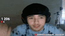 a man wearing headphones and a hat with the number 1206 above his head