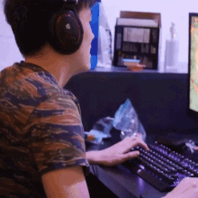 a person wearing headphones is typing on a keyboard