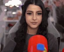 a woman wearing boxing gloves looks at the camera and smiles