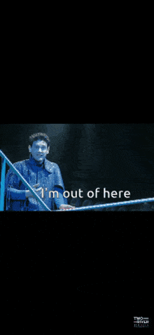 a man singing into a microphone with the words " i 'm out of here " above him