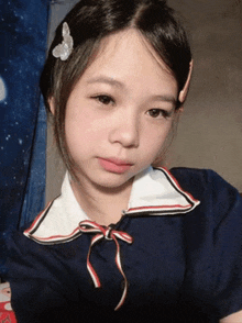 a young girl with a butterfly in her hair takes a selfie