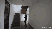 a woman is standing in a hallway next to a set of stairs made by animatica