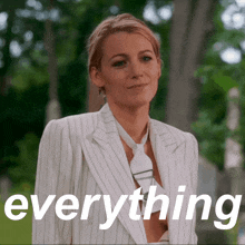 a woman in a striped suit and tie with the word everything above her