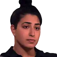 a close up of a woman 's face with a bun on her head