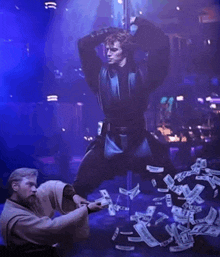 a man is standing on a pole with a bunch of money coming out of it