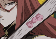 a close up of a person holding a fan with a pink bow on it