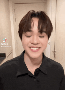 a tiktok video of a young man with his eyes closed and a smile