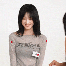 a woman wearing a grey shirt that says ' sox ' on it