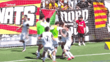 a soccer game is being played in front of a banner that says nats nord