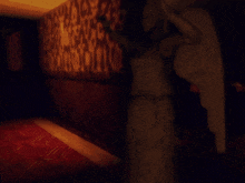 a dark room with a statue of a woman standing in the corner