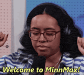 a woman wearing glasses and headphones says welcome to minn max
