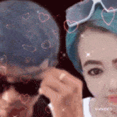 a man and a woman are standing next to each other with pink hearts around them