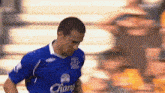 a soccer player wearing a blue shirt with the word champ on it