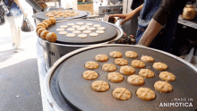 a bunch of cookies are being cooked on a stove and the words made in animotica are visible