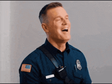 a police officer is laughing with his mouth open and his name tag says smith