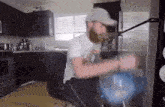a man with a beard is sitting in a chair in front of a refrigerator .