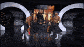 a group of men standing on a stage in front of a sign that says brillianttv