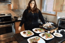 a woman is standing in a kitchen preparing food .