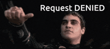 a man is giving a thumbs up with the words request denied behind him