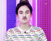 a man with a fake mustache wearing a striped shirt