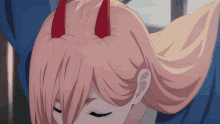 a close up of a girl 's hair with horns on it